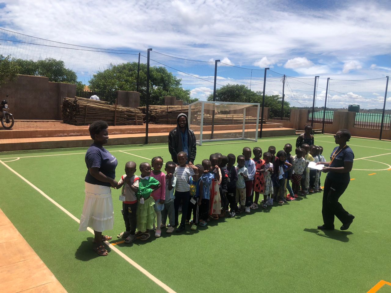 Nursery and reception children lined up with their teacher
