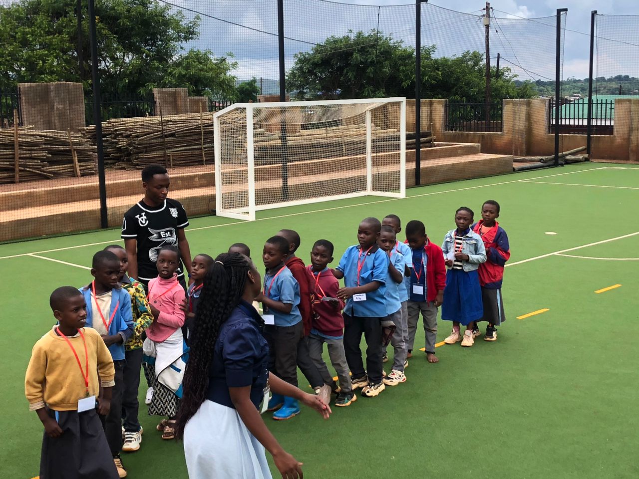 Primary-aged learners take part in activities on the court