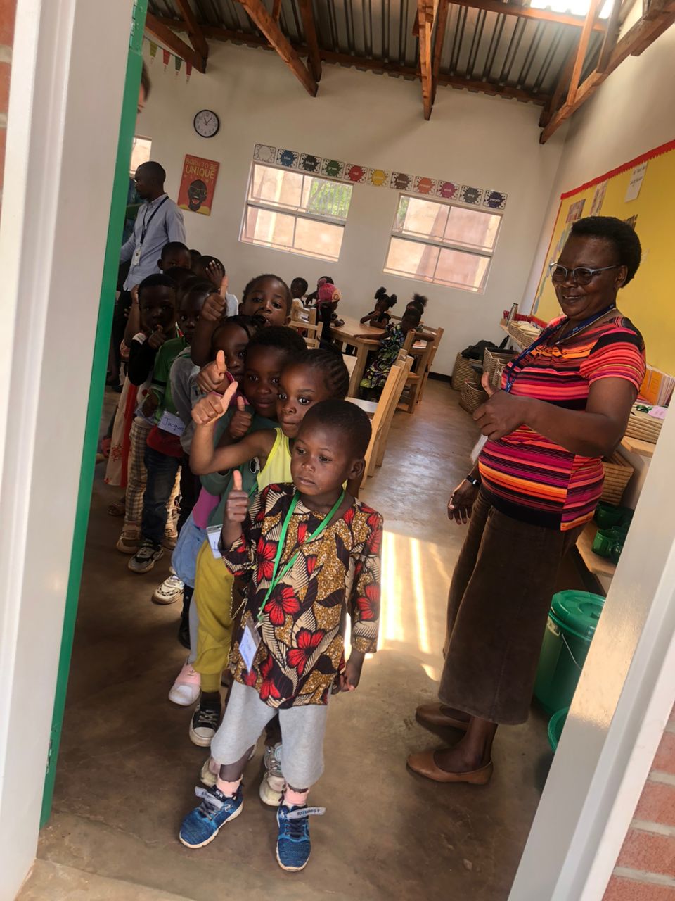 Teacher leading a number lesson on a classroom rug